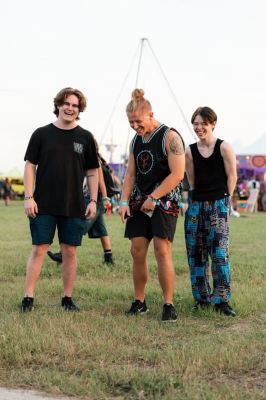 Three friends laughing at festival