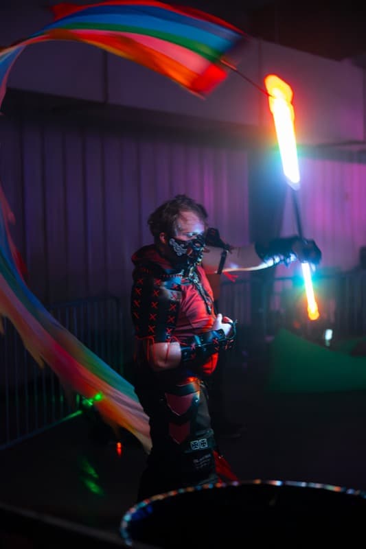 Performer with LED props at night